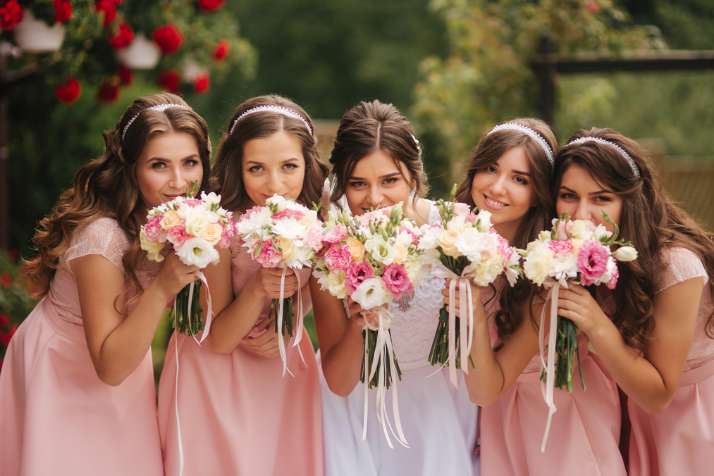 Bride with Bridesmaid Hold FlowerBouquets