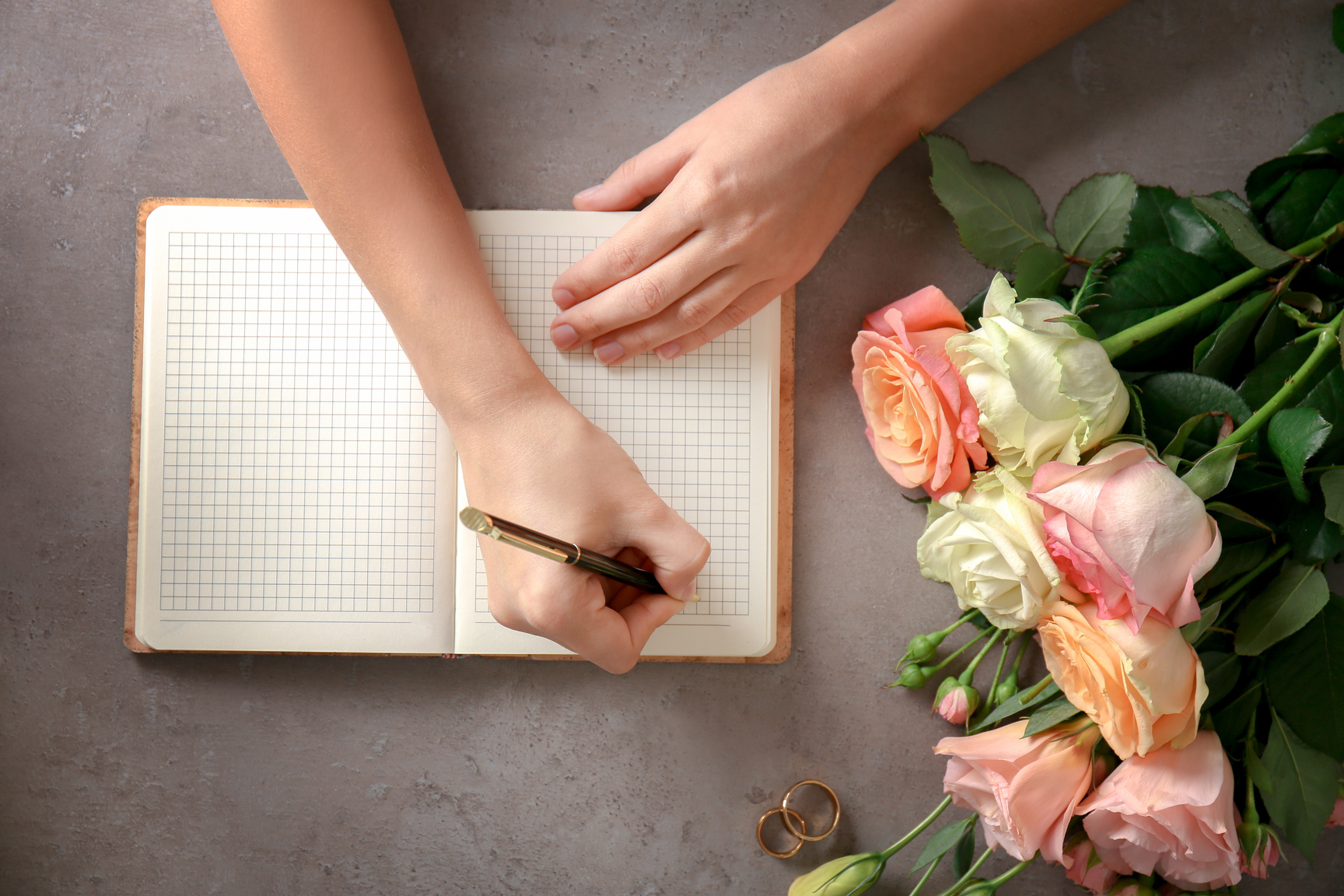 Person Writing Wedding to Do List on Table